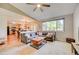Open living area leading into the kitchen with hardwood floors, a gray couch, and large window at 11303 Vernon Way, Parker, CO 80134