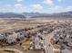 Neighborhood aerial view showcases well-maintained homes, streets, and distant mountain range at 15145 W Washburn Ave, Denver, CO 80228