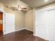 Bright bedroom showcasing dark floors, a ceiling fan, and a sliding closet at 15145 W Washburn Ave, Denver, CO 80228