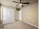 Cozy bedroom with carpet and a ceiling fan, featuring a closet and a neutral color palette at 15145 W Washburn Ave, Denver, CO 80228