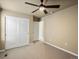 This neutral bedroom features a closet with white paneled doors and standard ceiling fan at 15145 W Washburn Ave, Denver, CO 80228