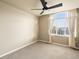 Inviting bedroom with carpet, neutral walls, natural light, and an arched window for serene living at 15145 W Washburn Ave, Denver, CO 80228