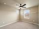 Comfortable bedroom with ceiling fan, neutral walls, carpeted floors, and natural light streaming through the windows at 15145 W Washburn Ave, Denver, CO 80228