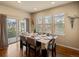 Dining area with hardwood floors and natural light from large windows at 15145 W Washburn Ave, Denver, CO 80228