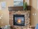 Close up of living room featuring a warm stone fireplace with decorative mantel and hearth at 15145 W Washburn Ave, Denver, CO 80228