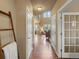 Hallway features hardwood flooring, neutral walls and doors leading into multiple rooms at 15145 W Washburn Ave, Denver, CO 80228