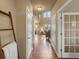 Hallway view showcasing hardwood floors, a decorative ladder, and access to multiple rooms at 15145 W Washburn Ave, Denver, CO 80228