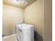 Functional laundry room featuring modern appliances, white cabinetry, and neutral tones for a clean and efficient space at 15145 W Washburn Ave, Denver, CO 80228