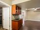 Open concept living room features a wet bar with dark wood cabinets and dark wood floors at 15145 W Washburn Ave, Denver, CO 80228