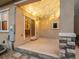 Covered outdoor patio with string lights and stone columns leading to the home's interior at 15145 W Washburn Ave, Denver, CO 80228