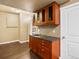 Finished basement featuring a wet bar with dark wood cabinets and a grey countertop at 15145 W Washburn Ave, Denver, CO 80228