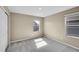 Neutral toned bedroom with plush carpet, natural light, and ample closet space at 20040 E 61St Dr, Aurora, CO 80019