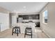 Bright kitchen with stainless steel appliances, a large center island with seating, and modern pendant lighting at 20040 E 61St Dr, Aurora, CO 80019