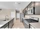 Spacious kitchen featuring stainless steel appliances, granite countertops, and wood-look flooring at 20040 E 61St Dr, Aurora, CO 80019