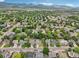 A scenic aerial view of a residential neighborhood featuring lush trees and mountains in the distance at 6017 S Pierson St, Littleton, CO 80127