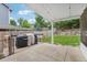 Backyard includes a covered deck with a grill, along with a well-maintained lawn and fence at 6017 S Pierson St, Littleton, CO 80127