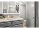 Bathroom with gray cabinets, a toilet, and an open doorway at 6017 S Pierson St, Littleton, CO 80127