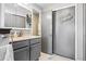 Bathroom with gray cabinets, mirror, and sliding closet with decal art at 6017 S Pierson St, Littleton, CO 80127