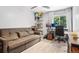 Cozy bedroom features a sofa, shelving unit with collectibles, desk and large window at 6017 S Pierson St, Littleton, CO 80127