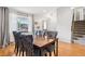 Dining room showcases a wood table with blue upholstered chairs next to a window and stairway at 6017 S Pierson St, Littleton, CO 80127