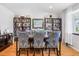 Bright dining room features a wood table, six blue upholstered chairs, and two tall, dark wood bookshelves at 6017 S Pierson St, Littleton, CO 80127