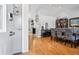 Open-concept entryway with hardwood floors leading to the dining area and kitchen at 6017 S Pierson St, Littleton, CO 80127