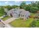 Charming home with a well-maintained lawn, brick accents, and an attached garage, nestled among mature trees at 6017 S Pierson St, Littleton, CO 80127