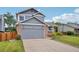 Charming two-story home with a brick and siding exterior and an attached two-car garage at 6017 S Pierson St, Littleton, CO 80127