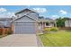 Charming two-story home with a brick and siding exterior and an attached two-car garage at 6017 S Pierson St, Littleton, CO 80127