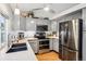 Gray kitchen with stainless appliances, countertops, and hardwood floors at 6017 S Pierson St, Littleton, CO 80127