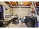 Unfinished basement laundry room features a washer, dryer, shelving, and exposed ceiling at 6017 S Pierson St, Littleton, CO 80127