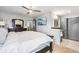 Spacious main bedroom with en suite bathroom, TV, ceiling fan and a large bed at 6017 S Pierson St, Littleton, CO 80127
