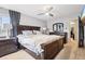 Primary bedroom features dark wood furniture, large windows, and neutral paint at 6017 S Pierson St, Littleton, CO 80127