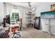 Bright and airy office with computer desk, shelving unit, and natural light at 6017 S Pierson St, Littleton, CO 80127