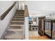 Carpeted staircase leading to the upper level, with a view of the living area and a fireplace at 6017 S Pierson St, Littleton, CO 80127