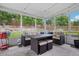 Bright sunroom with comfortable wicker furniture set, skylights, and views of the backyard at 6017 S Pierson St, Littleton, CO 80127