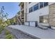 Spacious backyard with stairs to the upper deck and a patio with storage units and lounge furniture at 16345 Spanish Peak Way, Broomfield, CO 80023
