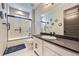 Modern bathroom with a tiled shower, dark accents, and a spacious vanity at 16345 Spanish Peak Way, Broomfield, CO 80023