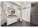 Modern bathroom featuring a vanity, shower, and stylish black and white accents at 16345 Spanish Peak Way, Broomfield, CO 80023