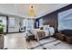 Spacious bedroom with tray ceilings, bench seat, textured accent wall, and natural light at 16345 Spanish Peak Way, Broomfield, CO 80023