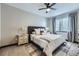 Neutral bedroom boasts a ceiling fan, natural light, and cozy furnishings at 16345 Spanish Peak Way, Broomfield, CO 80023