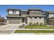 Contemporary two-story home featuring a manicured lawn and a two-car garage at 16345 Spanish Peak Way, Broomfield, CO 80023