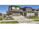 Stunning exterior showcasing the home's architecture, landscaping, and mountain views in the distance at 16345 Spanish Peak Way, Broomfield, CO 80023