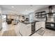 Modern kitchen with an island, wine cooler, stainless steel appliances, and an open living space at 16345 Spanish Peak Way, Broomfield, CO 80023