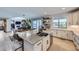 Open concept kitchen offers island with barstool seating and views into living and dining area at 16345 Spanish Peak Way, Broomfield, CO 80023