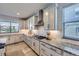 Charming kitchen offers granite countertops, stainless appliances, white cabinets and tile backsplash at 16345 Spanish Peak Way, Broomfield, CO 80023