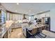 Bright kitchen features granite countertops, white cabinets, stainless appliances, and island with seating at 16345 Spanish Peak Way, Broomfield, CO 80023