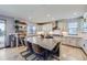 Spacious kitchen offers granite countertops, stainless appliances, island with barstool seating, and floating shelves at 16345 Spanish Peak Way, Broomfield, CO 80023