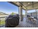Outdoor patio area featuring a grill, dining set, and stone-clad columns at 16345 Spanish Peak Way, Broomfield, CO 80023