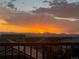 Scenic sunset view from the balcony of the home overlooking the mountains and houses at 16345 Spanish Peak Way, Broomfield, CO 80023